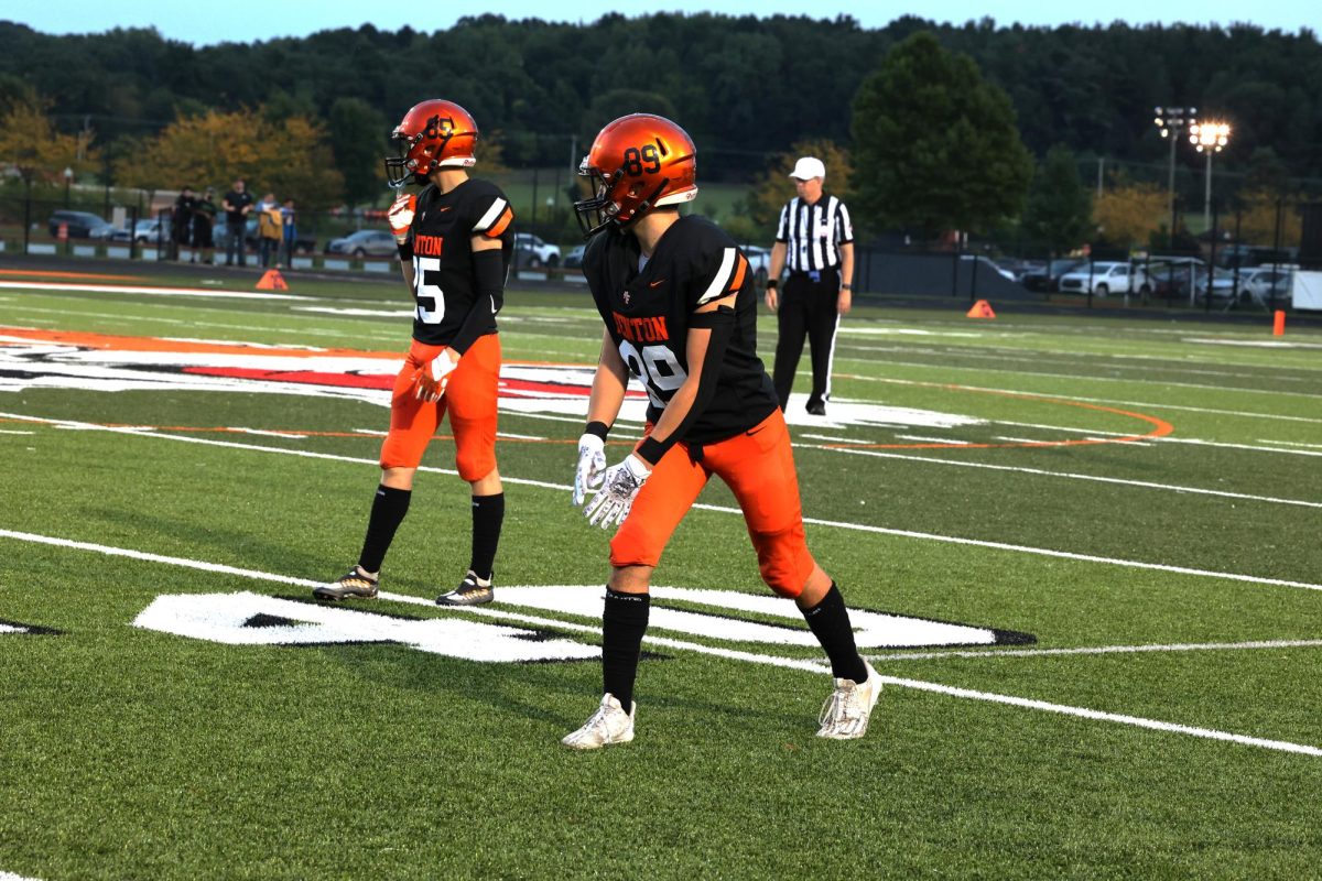 Preparing for the next play, sophomores Bennett Gudith and Nicholas Brown are in position at the line of scrimmage. On Sept. 21, the Tigers competed against Kearsley and won 51-0.