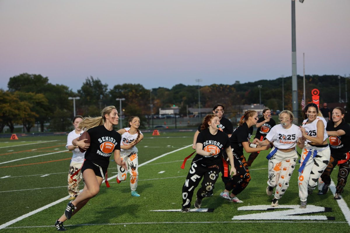 Running the ball, senior Sophie Smith breaks through the junior defense. On Oct. 2, The Fenton seniors defeat the junior in the annual powder puff game.