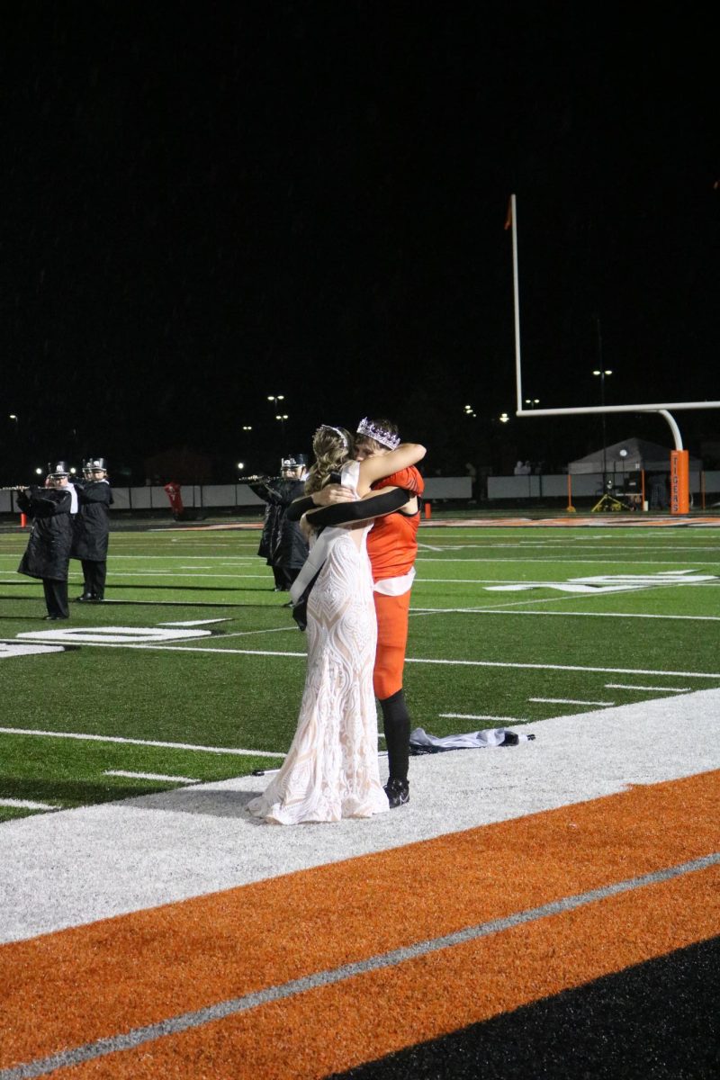 Hugging, seniors, Marissa Frazier and Jake Nichols are announced as homecoming King and Queen for the 2023-2024 school year. On Oct. 6, at half time, homecoming court was presented. 