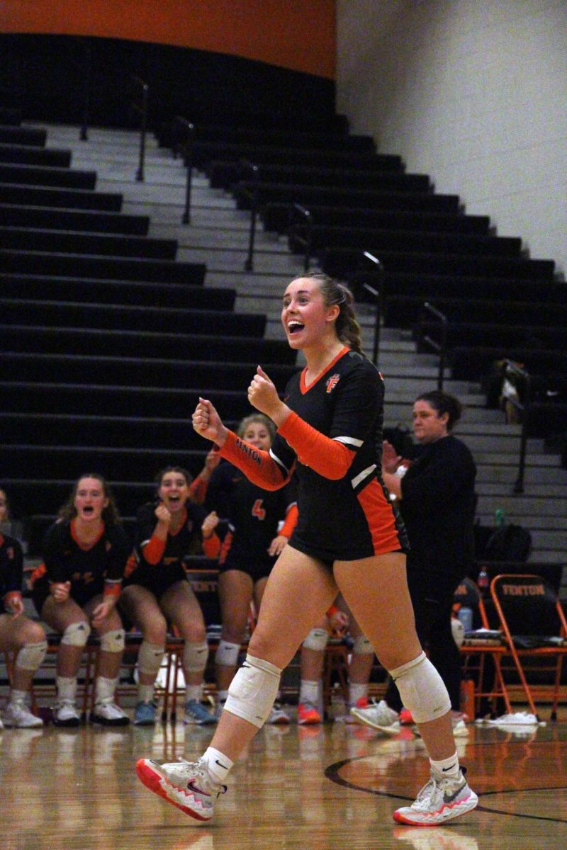 Celebrating, Marissa Frazier looks at her teammates. On Oct. 5, the Varsity Volleyball team competed against Swartz Creek, winning 3-0. 