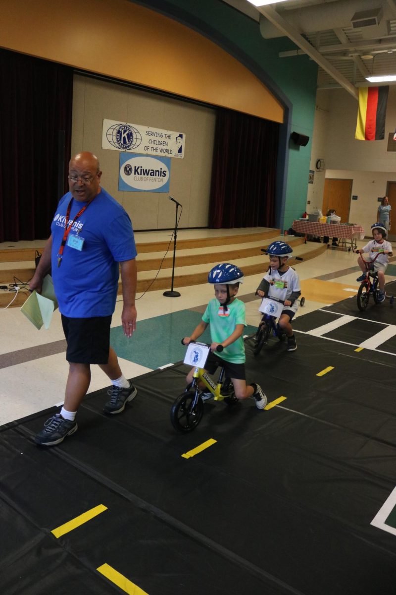 Walking, teacher Lou Santo leads children on bikes. On Aug. 7, State road hosted safety town to help the kids learn about street safety.