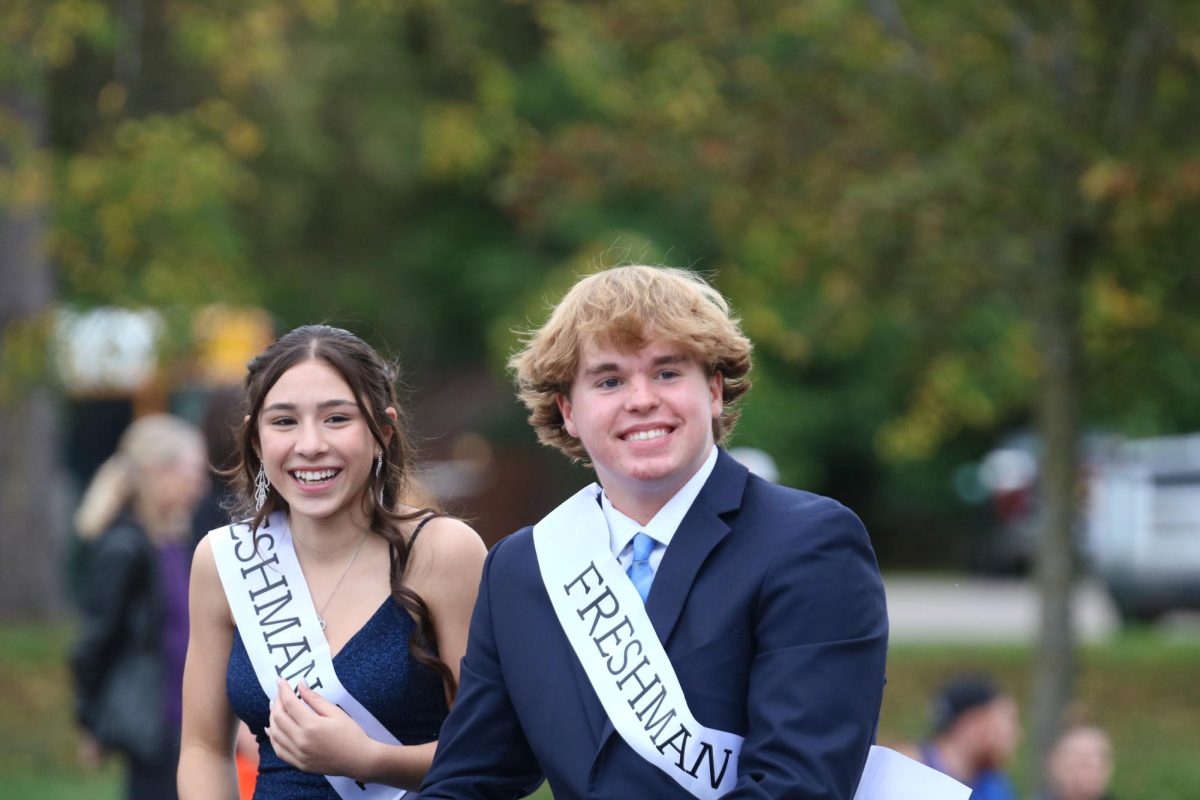 Riding in the Fenton parade Freshman Alexis Roberts and Thomas Chanter smile for the crowd. On Oct. 6, all of Fenton Schools participated in the annual Homecoming Parade.