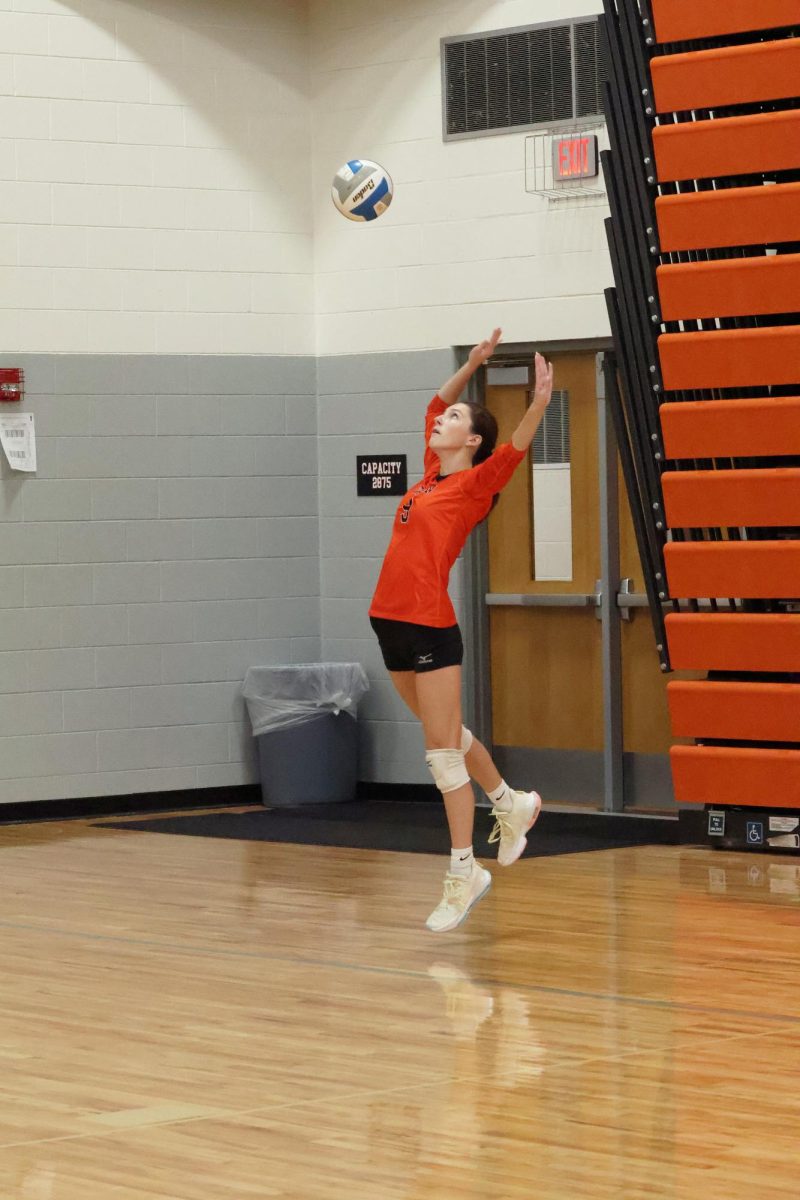 Jumping, Sophomore Addison Smith serves the ball. On Oct.18, the fenton JV volleyball team competed against Flushing high school and won 3-0.