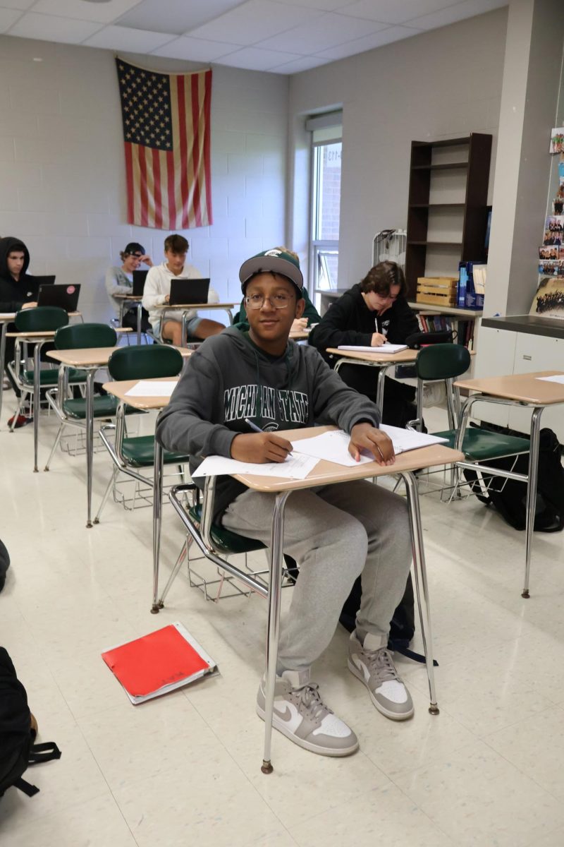 Repping MSU, freshman Jerome poses while doing his class work. On Oct. 2nd, the theme for the day was Michigan VS Michigan State.