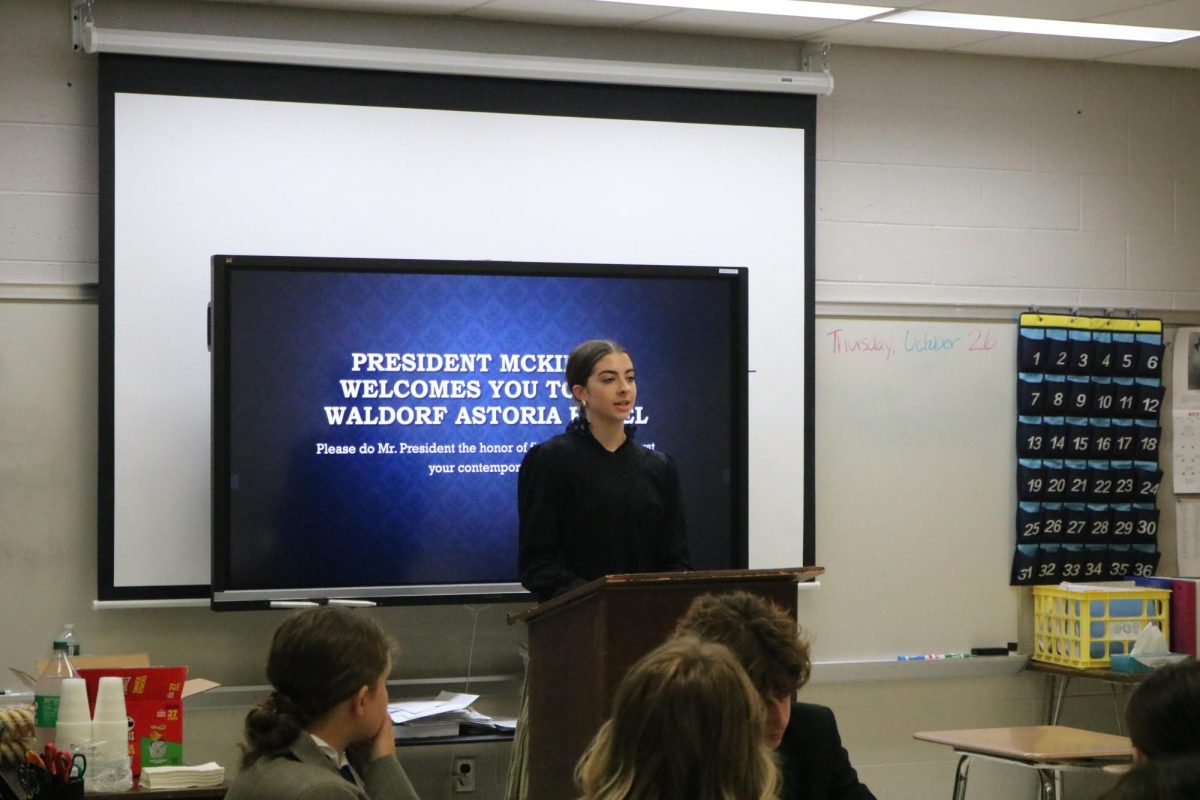 Speaking to the class, sophomore Karley Russel participates in the AMS Tea Party. On Oct. 27, the AMS program speaks to their class about president Mckinley.