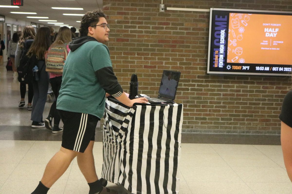 Walking in the square, Senior Lance Sanchez participates in spirit week. On Oct 4 Fenton highschool students participated in the “anything but a backpack day” for homecoming spirit week. 
