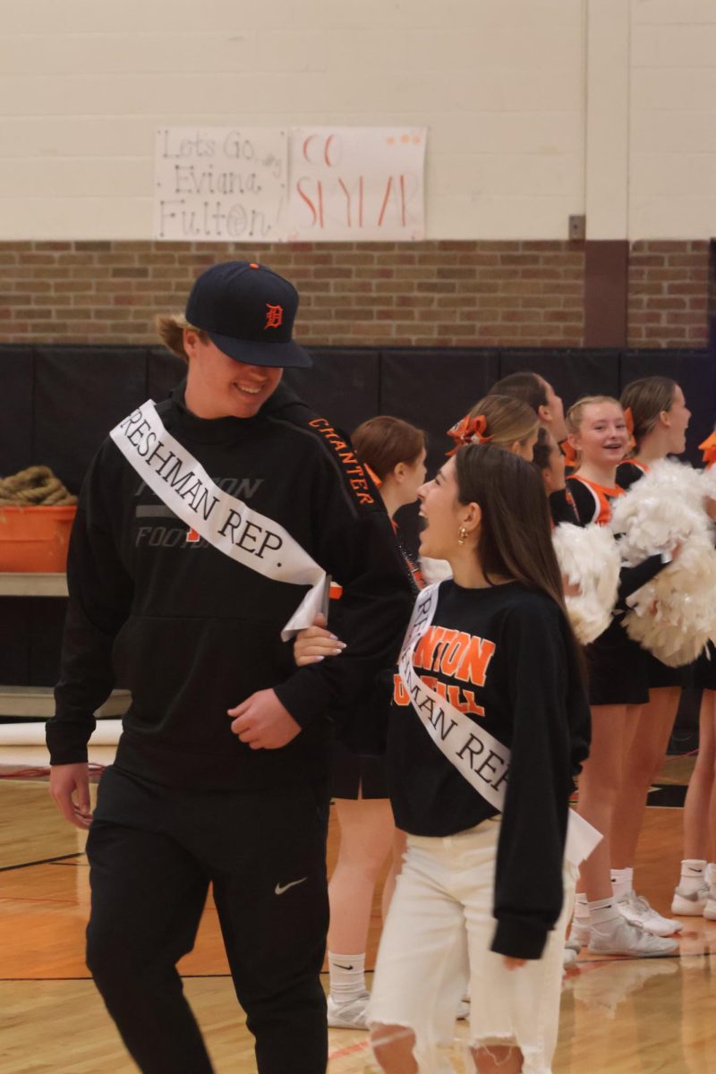 Walking, freshman Alexis Roberts and Tommy Chanter get introduced during the pep assembly.  On Oct. 6 Fenton held the pep assembly where homecoming court was announced. 