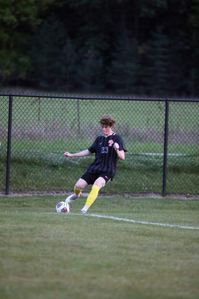 Kicking it from the corner, senior Tyler Levely tries to help his teammates score. On Sept. 21, The FHS varsity boys soccer team played against Groves high winning 2 to 1.