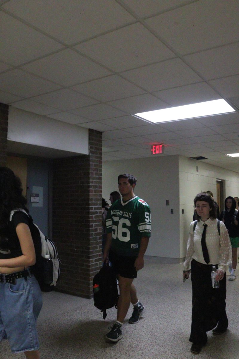 Walking, senior Chris Piwowarczyk shows his spirit. On Oct. 2 the spirit day was Michigan vs. Michigan State.