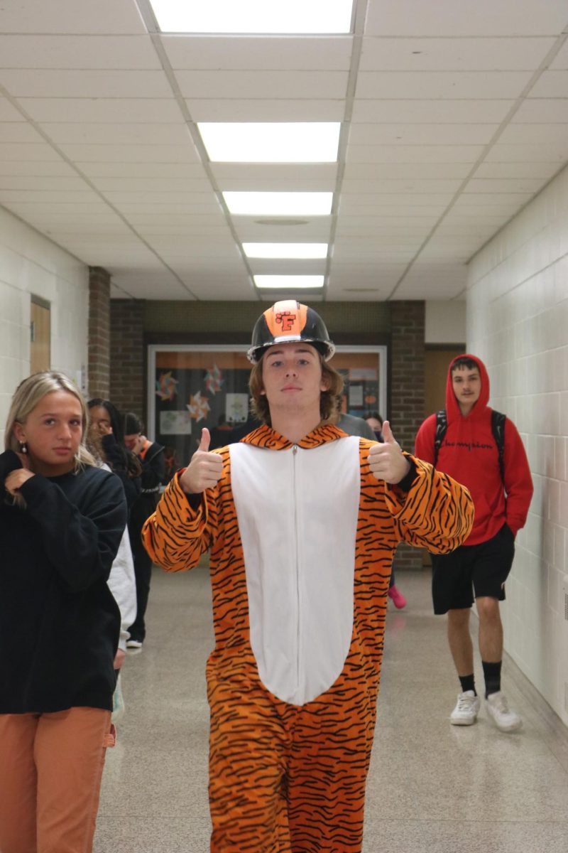 Showing his pride, senior Brenden Phillips dresses up as a tiger for spirit week. On Oct. 6, the spirit week them was orange and black.