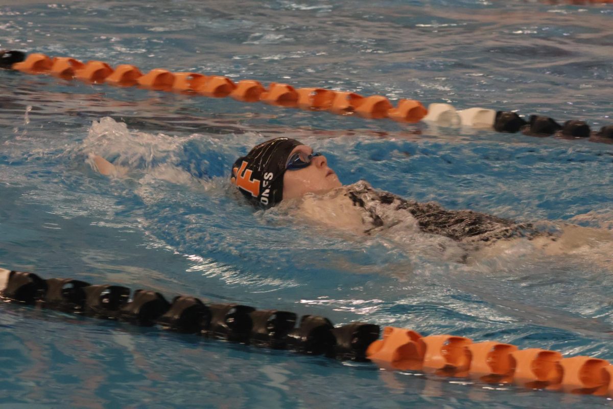 Competing in backstroke, junior Hannah Jones races against Brandon. On Oct.12  the Tigers won the meet.  