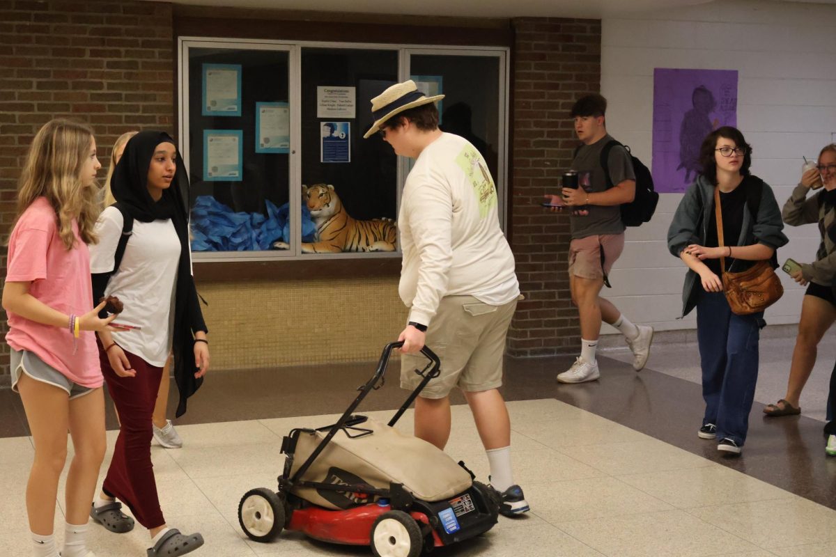 Walking with his lawn mower sophomore Hunter Sayer participates in spirit week. On Oct. 4, the FHS staff and students participated in spirit week the  theme was anything but a backpack day. 