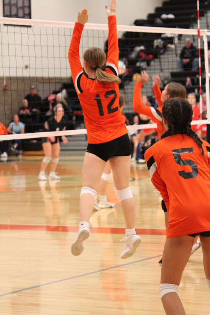 Jumping in the air, Freshman Maryn Teddy blocks the ball. On Oct. 16, the freshman volleyball team played against Linden. 