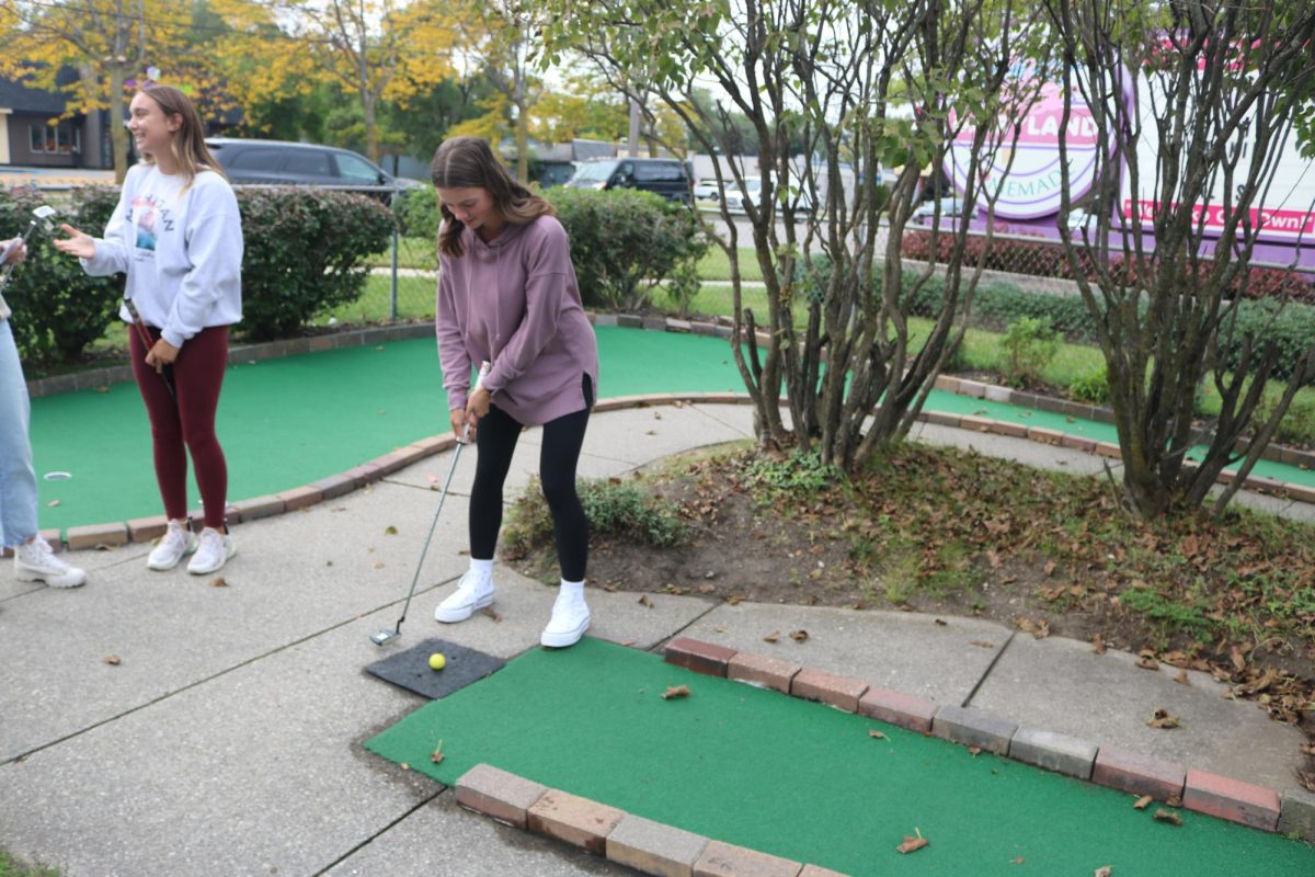 Playing against her teammates, Payton LaRowe plays putt putt. On Sept 26, the girls golf team played putt putt at Uncle Rays. 