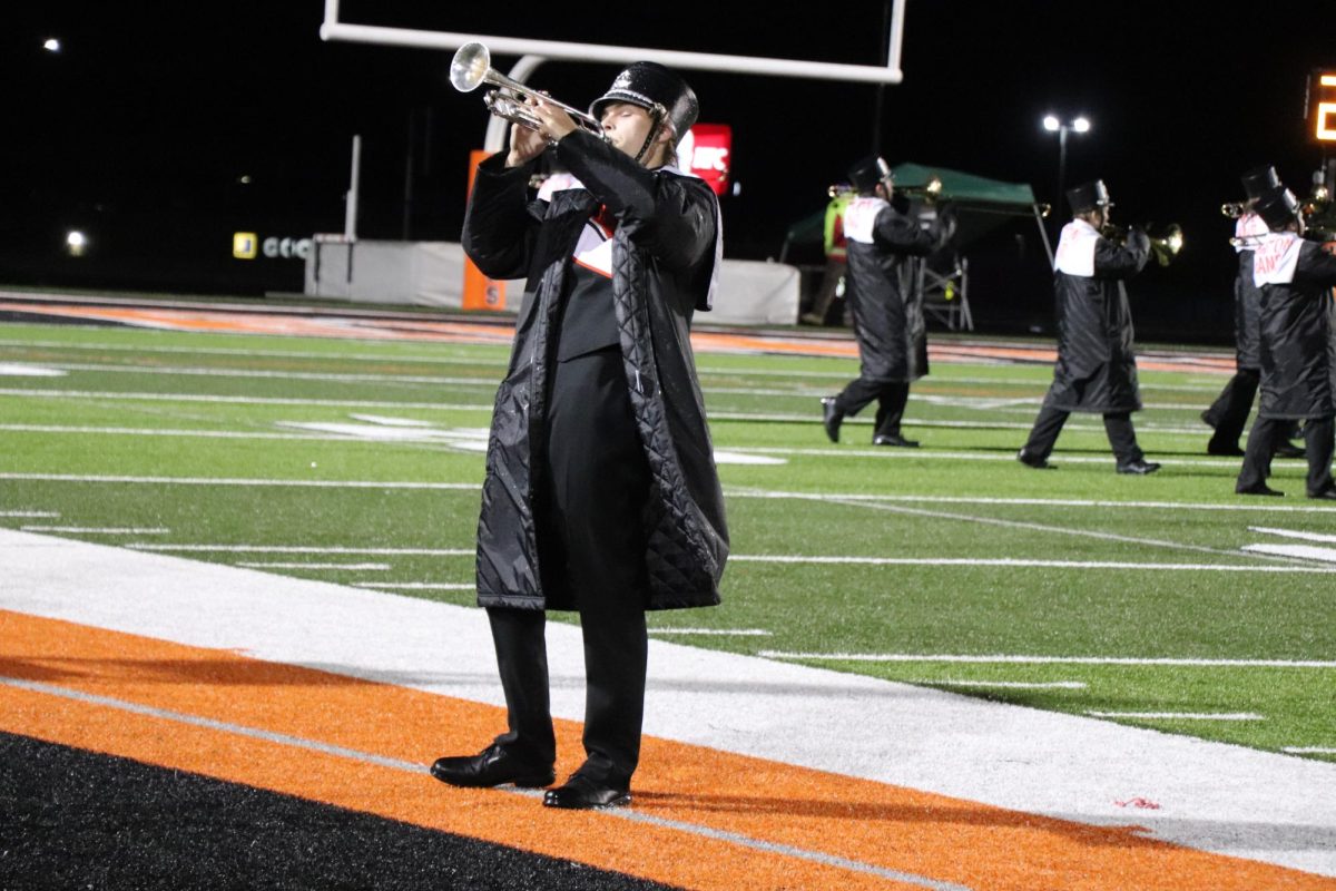 Performing, senior Daniel Martens plays at the last FHS football game of the season. On Oct 20. the marching band performs during halftime.