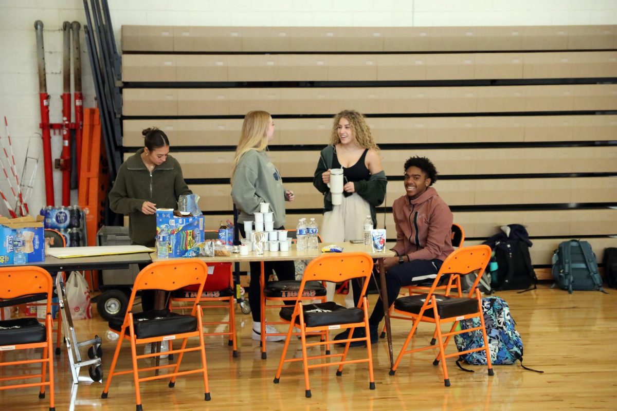 Making posters, Seniors Jillian Shanahan, Olivia Shampo, and JaHion Bond laugh while helping at the blood drive. On Nov. 10, Fenton High School holds its first Blood drive of the year.
