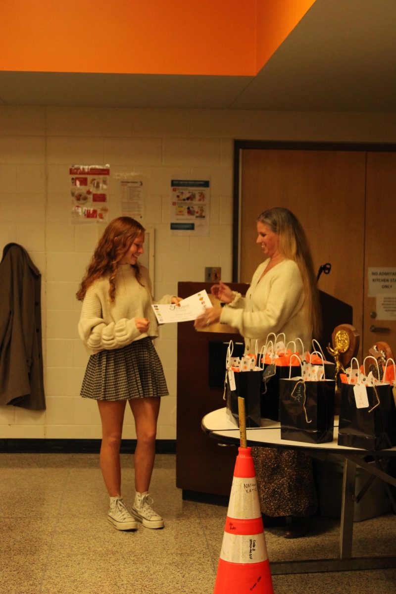 Smiling%2C+senior+Nina+Frost+receives+her+fourth+varsity+award+for+cross+country.+On+Oct.+18%2C+the+cross+country+teams+held+their+banquet+to+acknowledge+all+their+athletes.