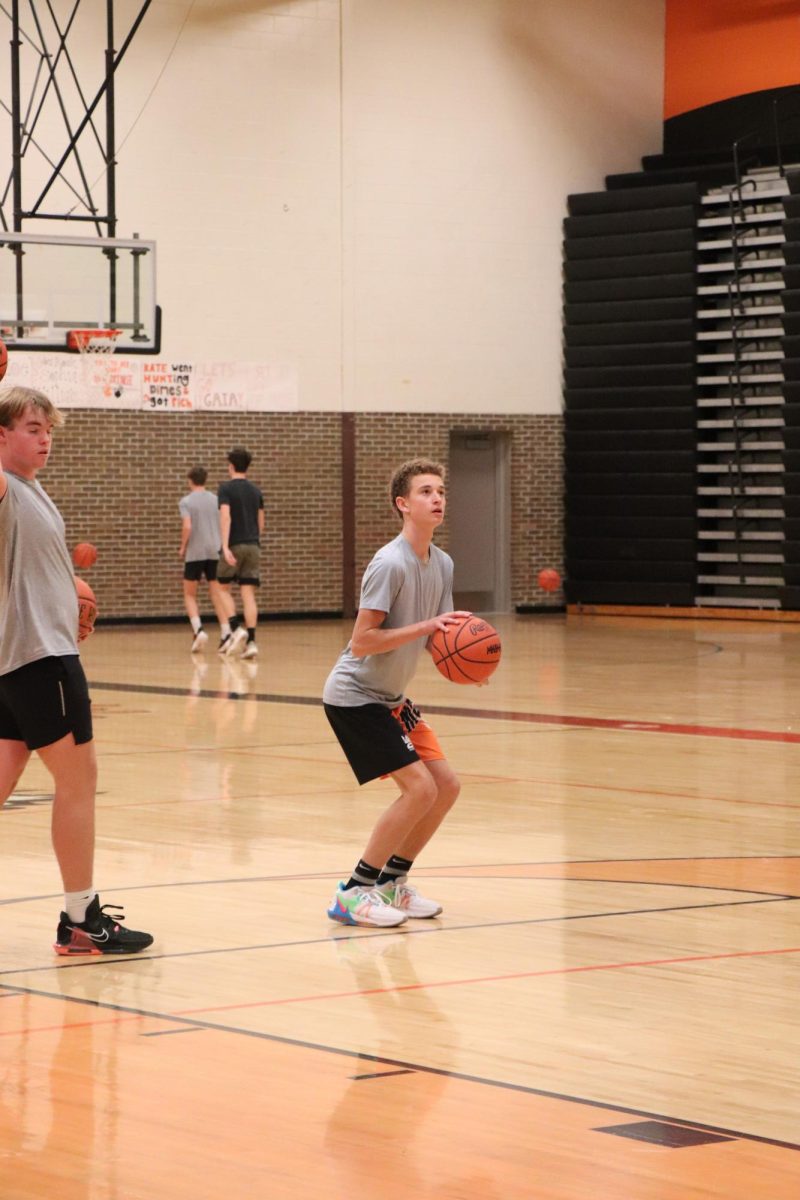 Getting ready to take his shot, freshman Tanner Craven practices before tryouts. On Nov. 14, the boys freshman basketball team held their second day of tryouts.