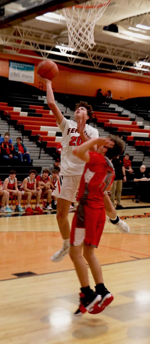 Jumping, freshman Zack Pierson attempts a layup. On Dec. 1, the boys freshman basketball team went up against Bedford winning 56-35.