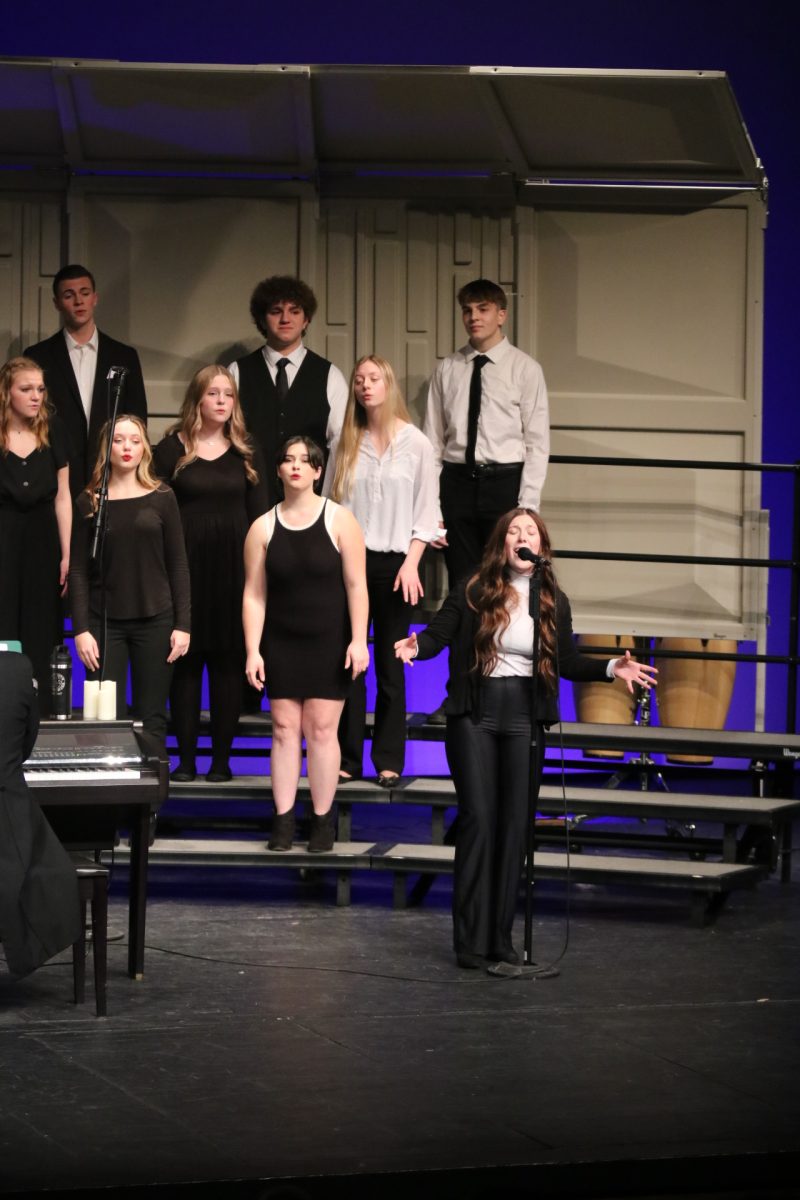 Preforming, senior Marlo Risner belts her solo through the Ruby Zima Auditorium. On Dec. 12, the fenton ambassadors preformed for the community at their winter concert. 