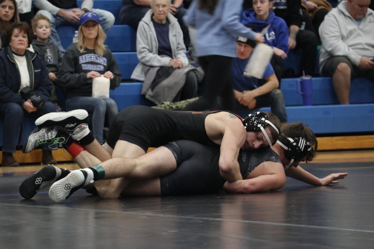 Wrestling, Junior Kaleb Digiacomo attempts to pin his opponent. On Dec. 6, the FHS boys varsity wresling team went up against Lake fenton and won 42 - 34.