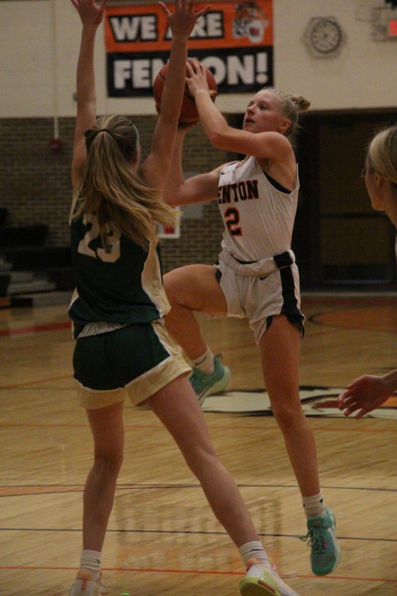 Jumping, Junior Izzy MacCaughan attempts to score. On Dec. 6, the Girls Varsity basketball team competed against Notre Dame Prep, losing 35 to 47.