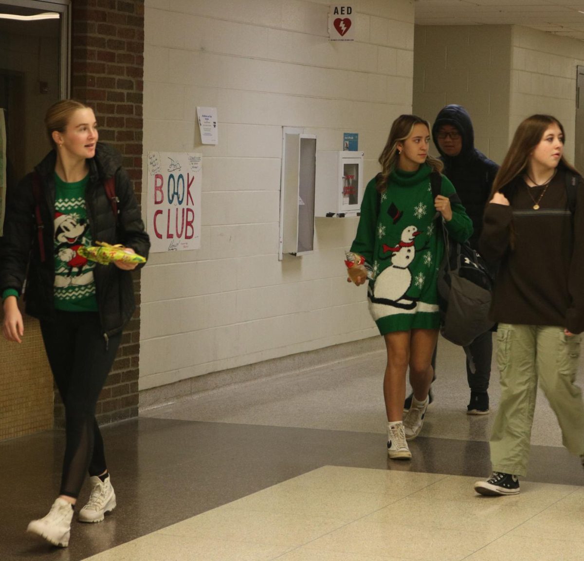 Walking, Freshman Sage Menzies particapates in ugly sweater day. On Dec 15, FHS concluded their holiday spirit week.