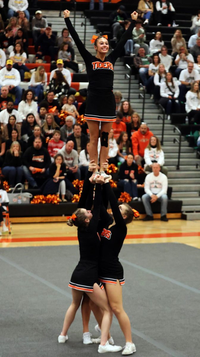 Posing, senior Jillian Shanahan competes in round three. On Dec. 9, the Fenton Cheer Team hosted the CCCAM Scholarship Invite and took 4th place. (Click to see full photo)