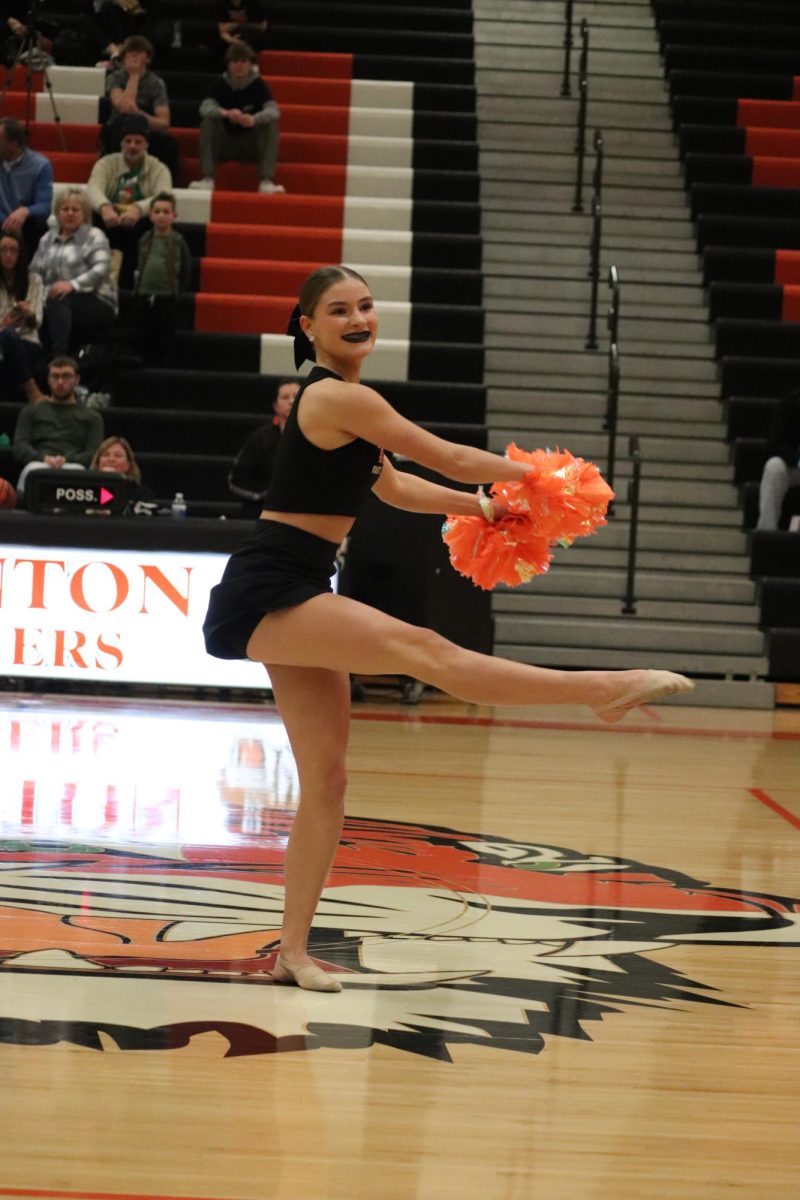 Turning, Junior Paige Lefever is in the middle of a spin. On Dec. 8, the Fenton Dance Team performed at the girls and boys basketball games during halftime.