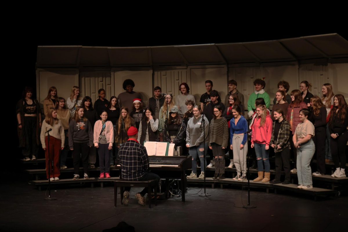 Practicing, the FHS choir prepared for their upcoming concert. On Dec. 12, during SRT the students did a run through of the performance. 