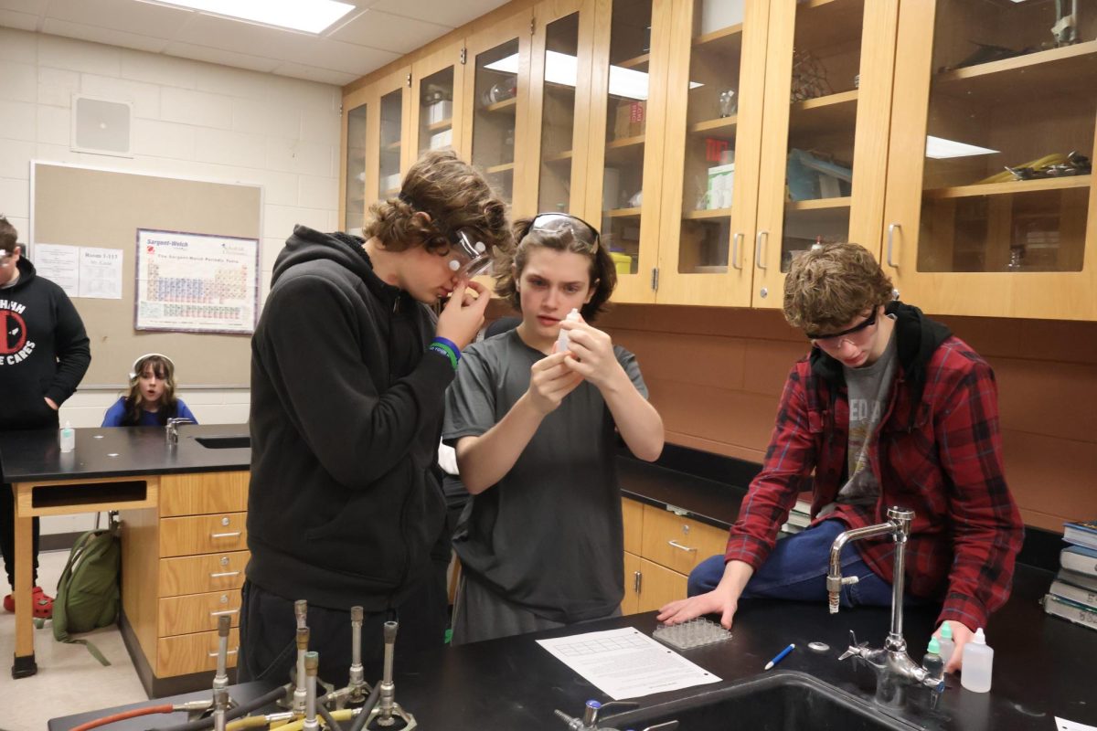 Learning, sophomores Stark Colony, Avery Ostrander and Parker Senyk participate in a lab. On Dec.14, teacher Jason Kasak held a physical science lab for his students.  