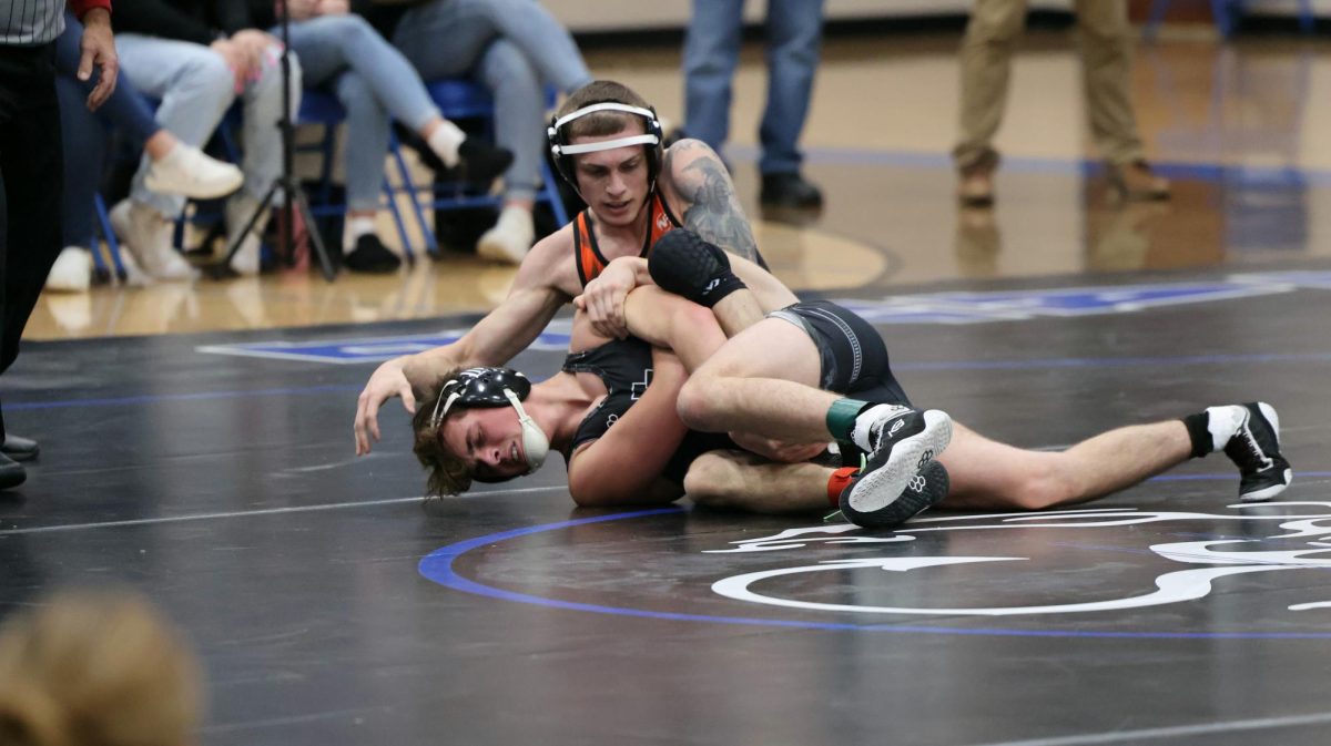 Wrestling%2C+Junior+Kaleb+Digiacomo+attempts+to+pin+his+opponent+from+New+Lothrop.+On+Dec.+6%2C+the+Fenton+Tigers+faced+off+against+the+Hornets+and+won+with+a+score+of+43-30.