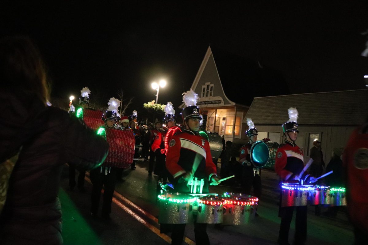 PLaying Jingle Fest Rock, the FHS marching band performs along the parade route. On Dec. 2, the annual Jingle Fest celebration took place.