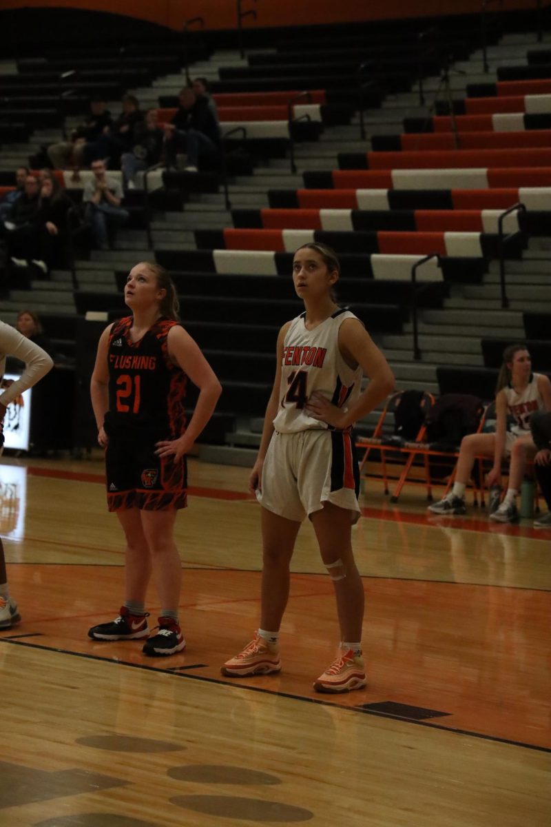 Watching an opposing player shoot a free throw, freshman Sage Menzies waits to box out her opponent. On Dec. 8, the JV girls basketball team played the Flushing Raiders and lost 10-45.