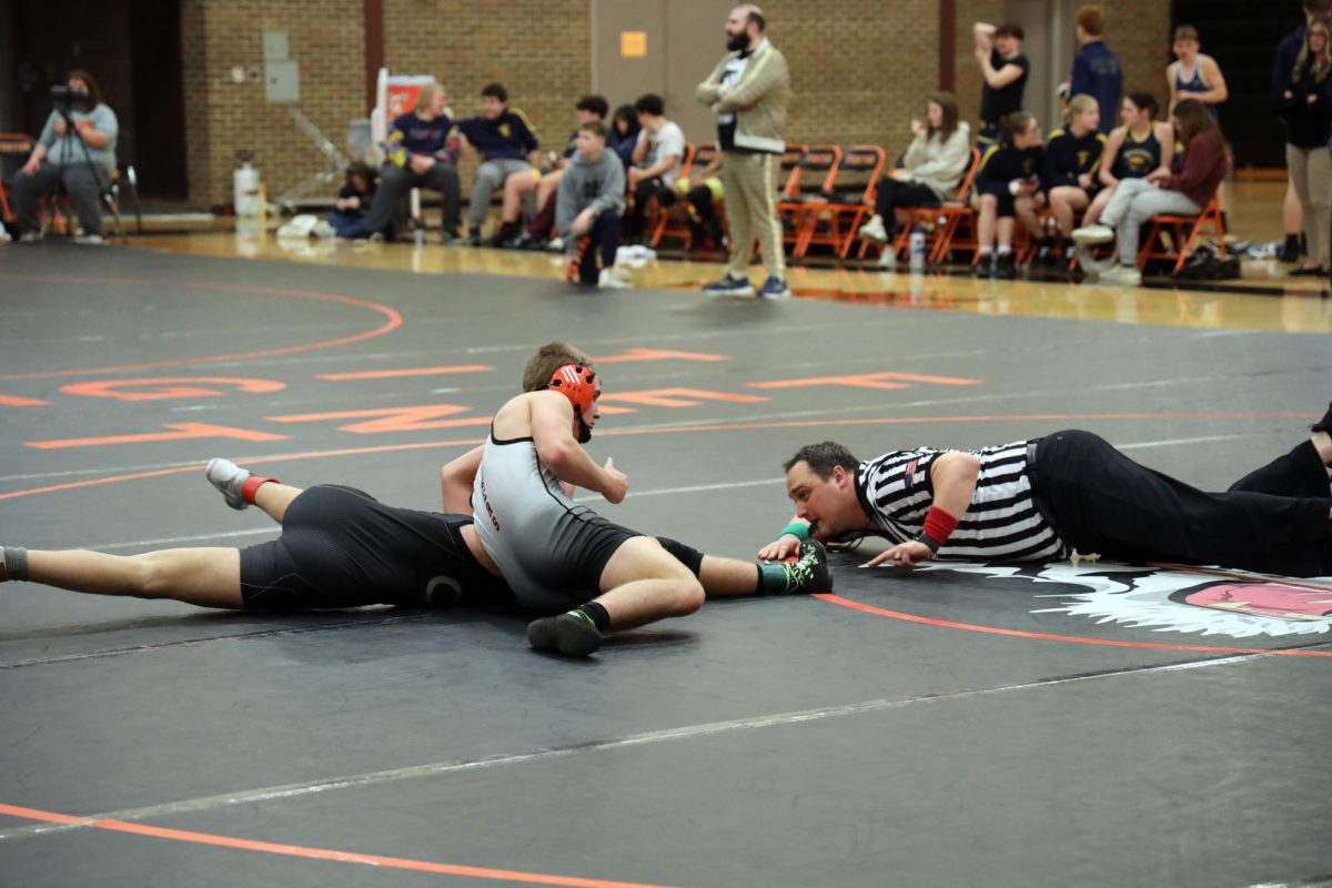 Looking for the pin, senior Garrett Clark gets his individual win over his opponent. On Jan. 24, the Fenton Tigers had a Dual against Flushing and Corunna winning both.