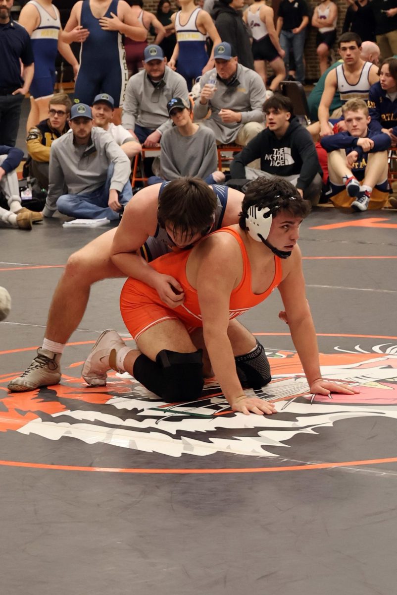Wrestling, senior Carson Krzeszak starts off round two on the bottom. On Jan. 27, Fenton wrestled Hartland at our home tournament for the championship. 