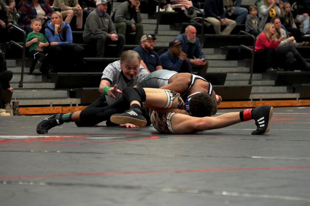 Pinning, Sophmore Anthony Benedict ends the round in a victory. On Jan. 24, the Fenton Tigers faced Flushing and Corunna defeating both.