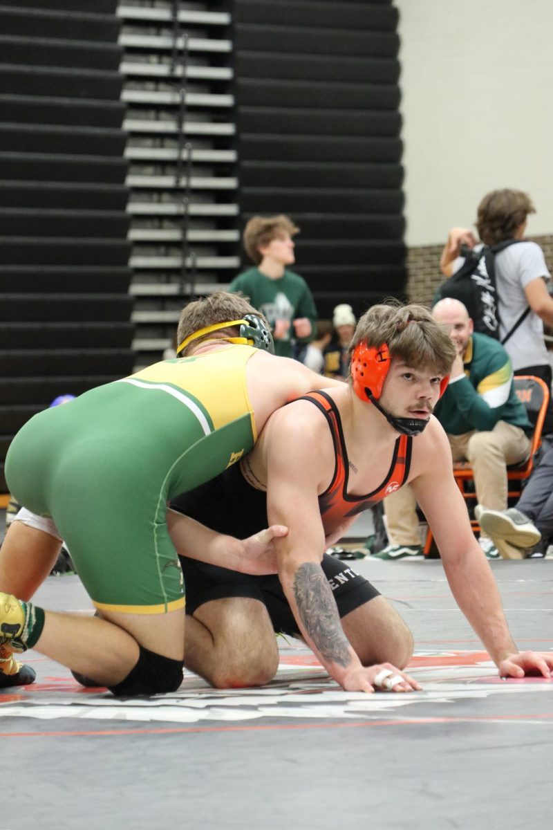 Sitting in position, Senior Philip Lamka defeats his opponent. On Feb. 27, the Fenton Wrestling team hosted a tournament taking first.