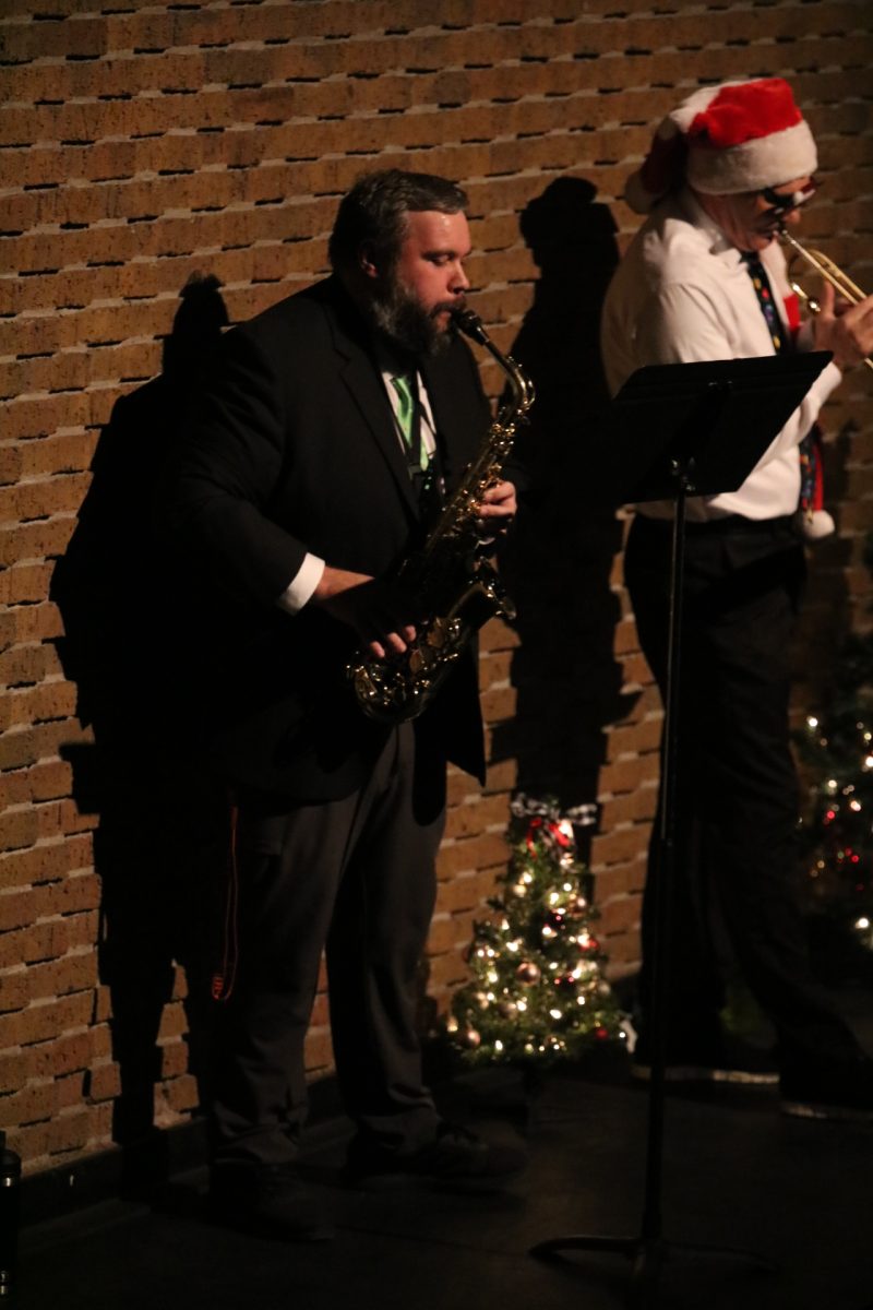 Performing, vice principal Zachary Bradley plays the saxophone. On Dec. 14, the band performed a christmas concert in the Ruby Zima auditorium at Fenton High.