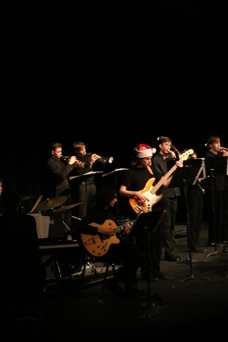 Playing their instruments, the FHS band plays christmas songs. On Dec. 14, the band students performed in the FHS auditorium.