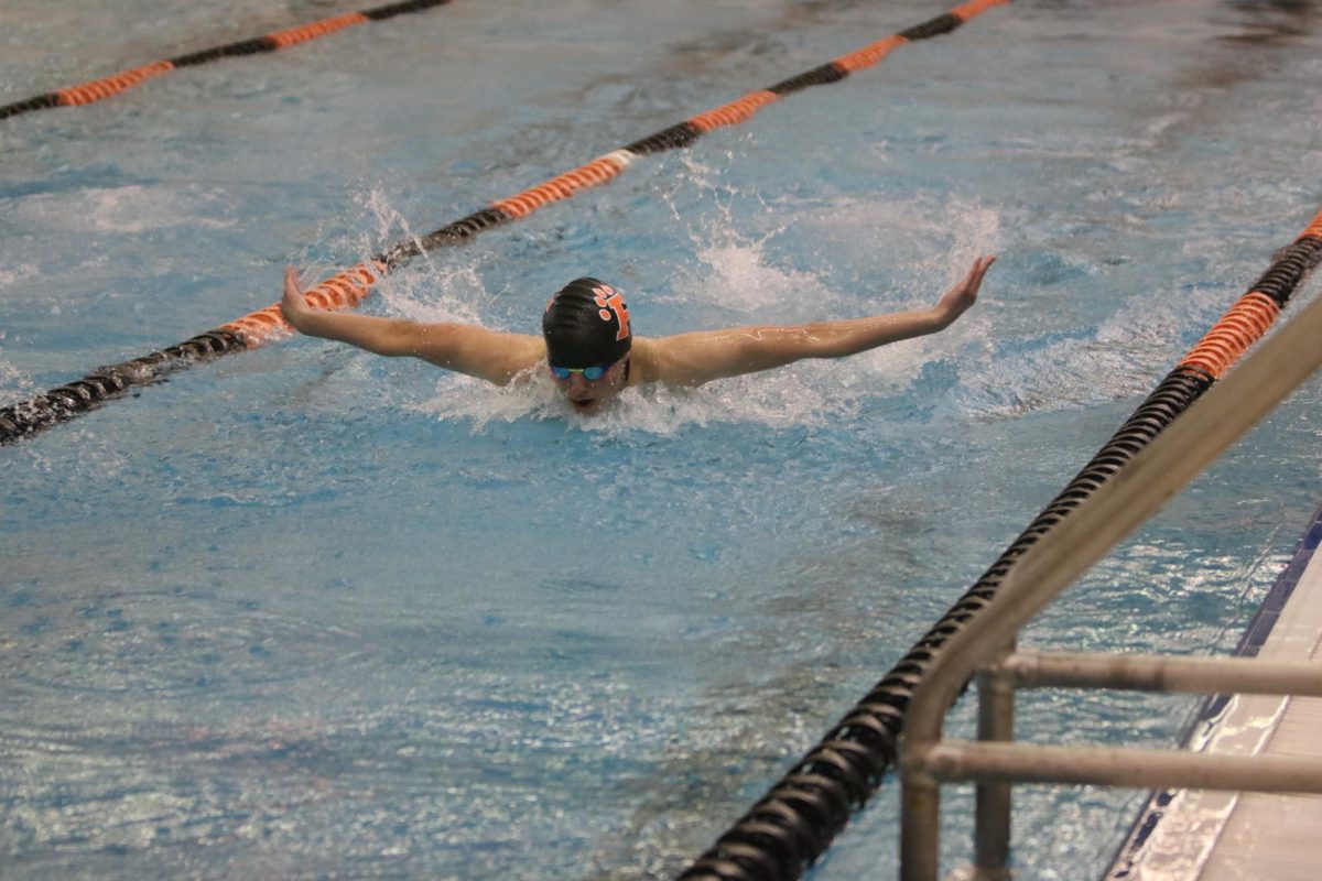 Swimming, Nate Hartzell participates in a competition. On Jan. 25,  the FHS boys swim team competed against Swartz Creek.