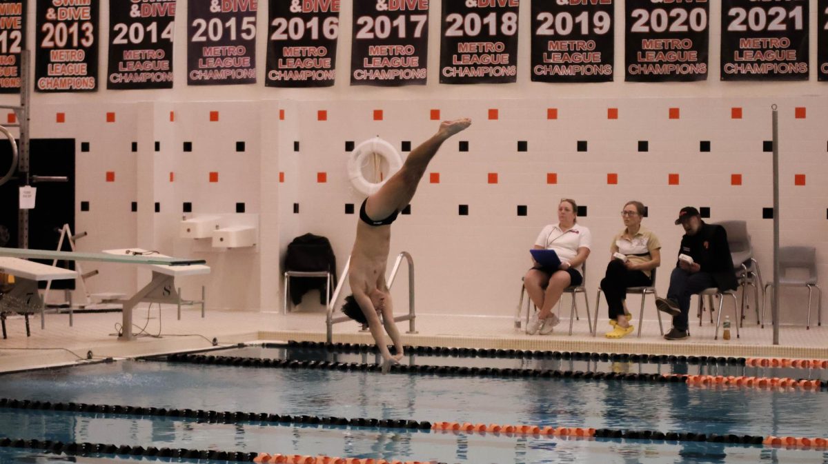 Diving, junior Owen Cox takes first at a dual meet. On Jan. 11, Fenton boys swim and dive competes against Corunna high school winning 102 - 77. 