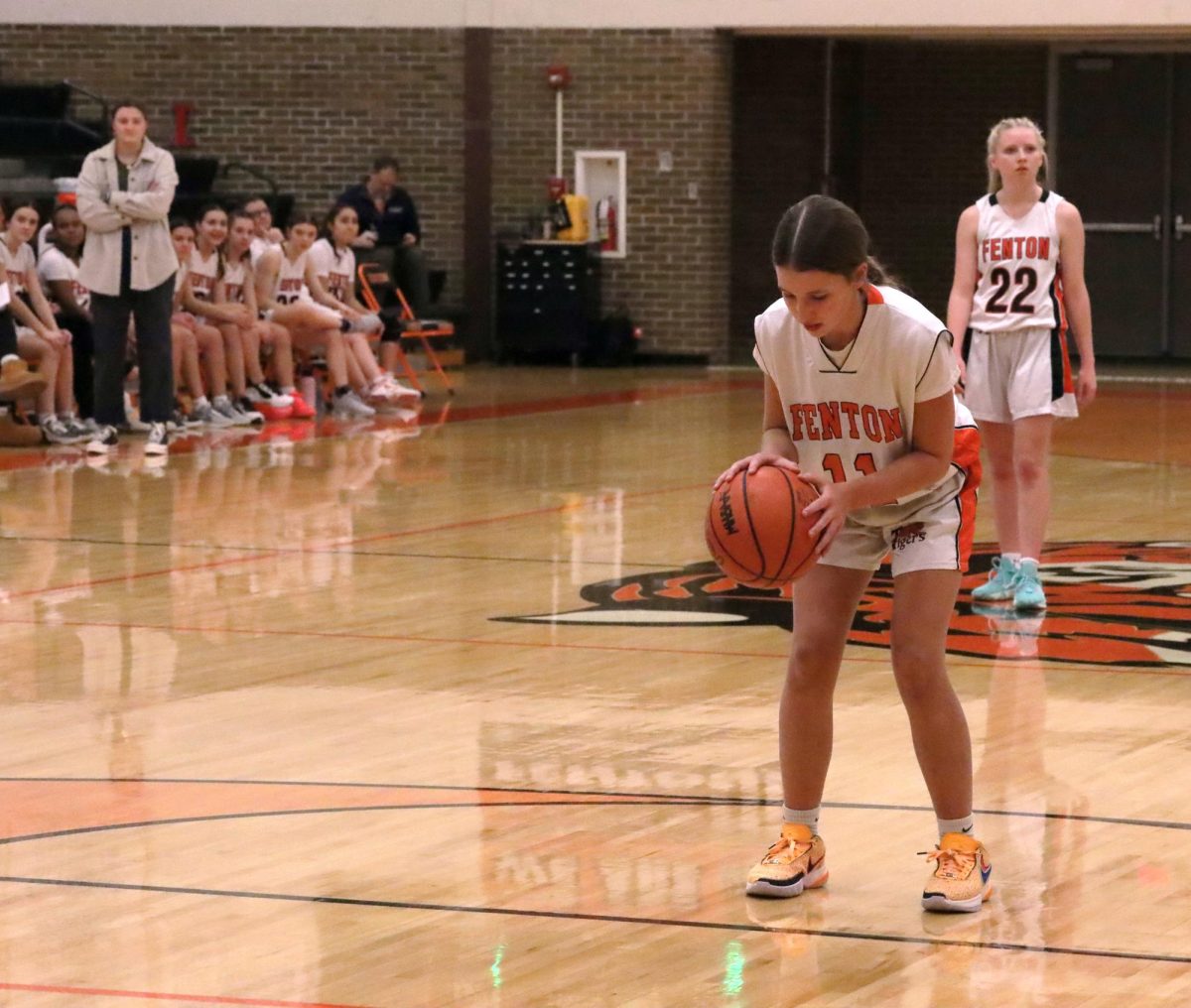 Preparing to shoot a free throw, freshman Madison Eltringham starts her routine. On Jan. 8, the JV girls basketball team faced off against the Holly Broncos and lost 24-25.