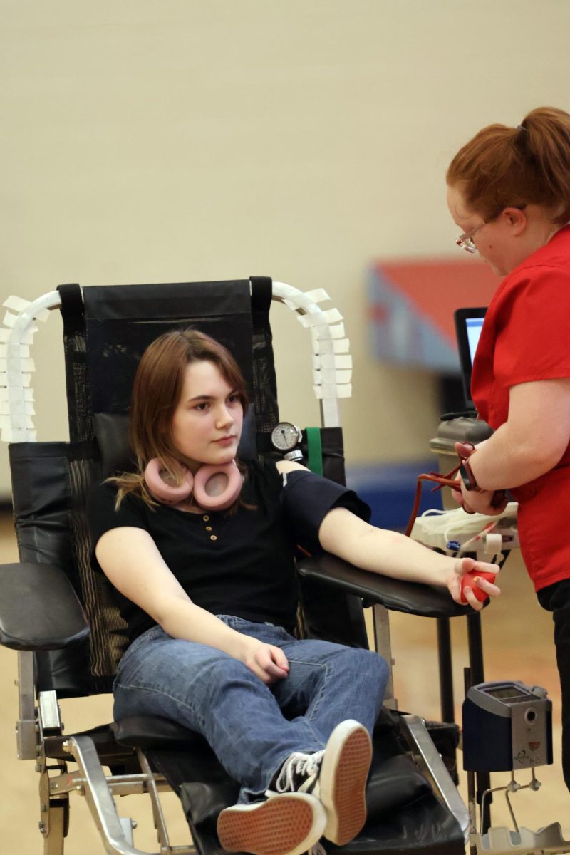 Getting her blood drawn, senior Emily Wallace participates in the blood drive. On Feb. 2, a hospital came to Fenton Highschool and took blood from participants.