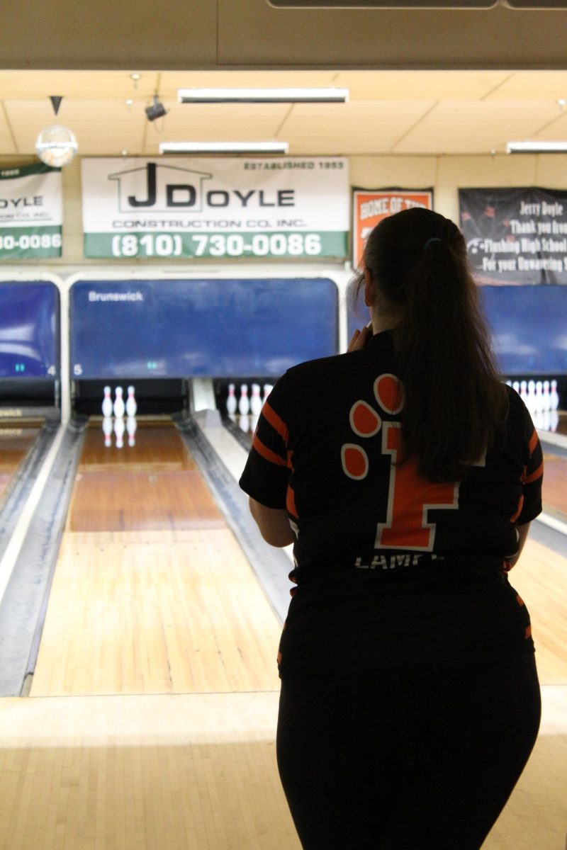 Getting ready to bowl, junior Faith Lampe walks up to the lane. On Feb. 17 the Girls Varsity Bowling Team played their last game of the season.