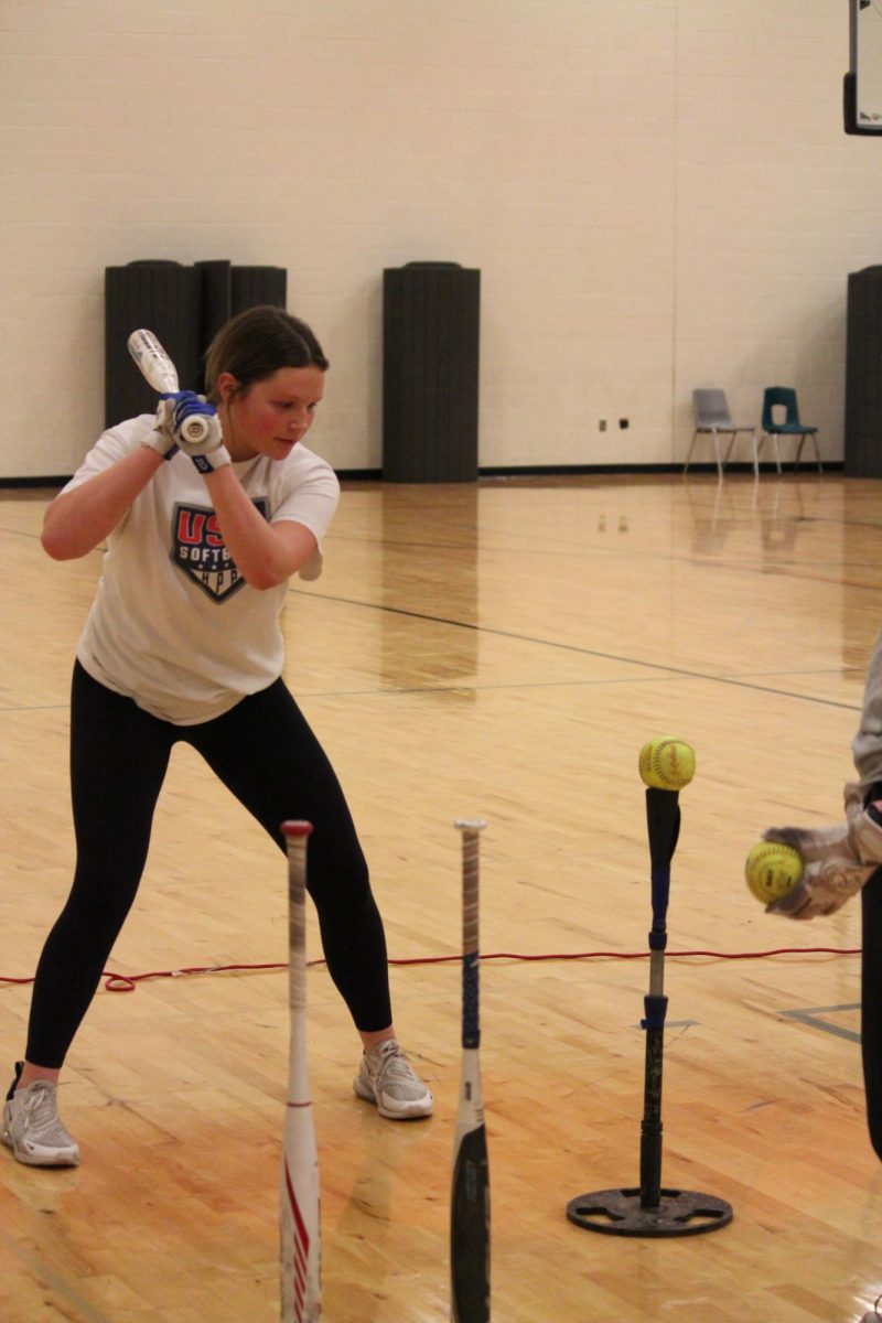 Swinging, freshman Lillian Tillier is hitting the ball. On Feb. 21, the Fenton Varsity softball team had an open gym. 