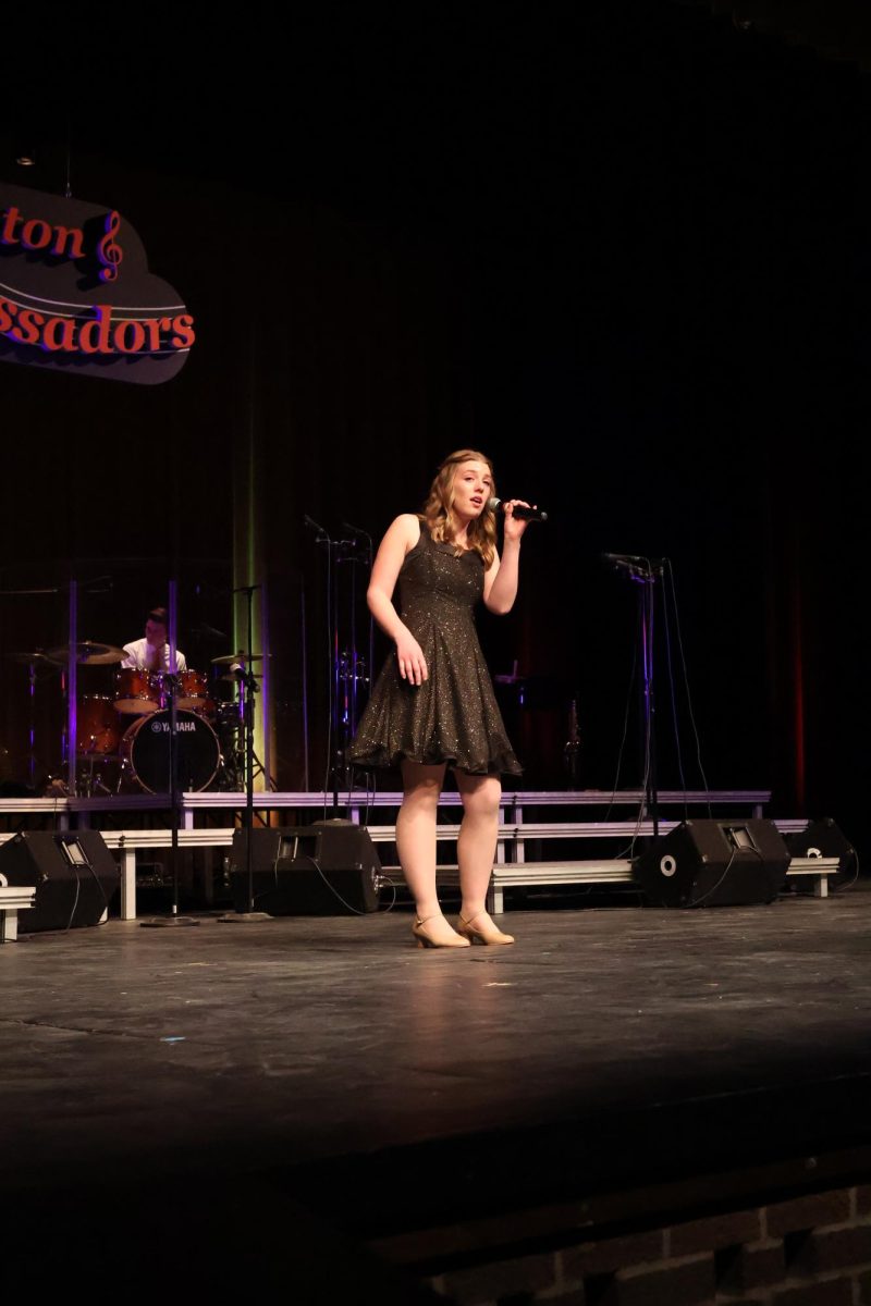 Singing, senior Ida Fraker performs her solo. On Feb. 23, the Fenton Ambassadors held there back by popular demand concert.