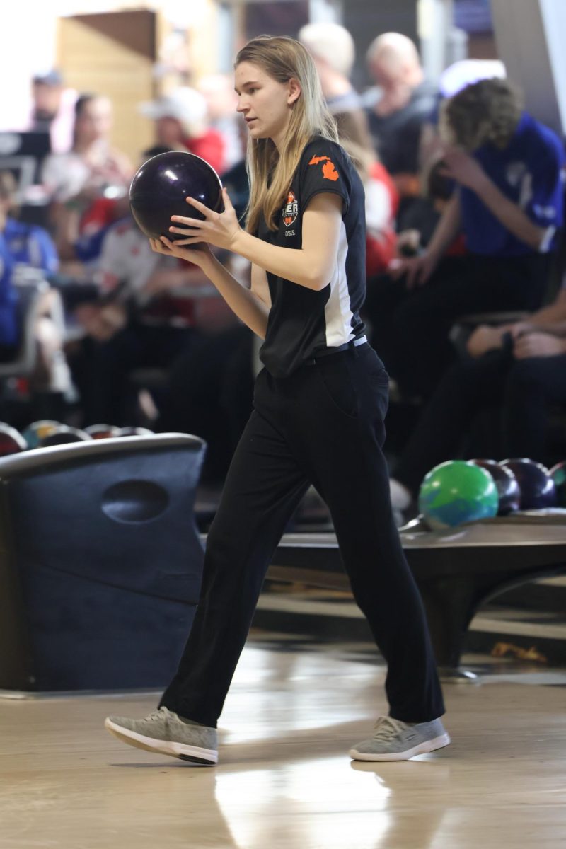 Walking up, junior Josie Jackman prepares to release the ball down the lane. On Feb. 5, the girls bowling team beat Linden 27-3.