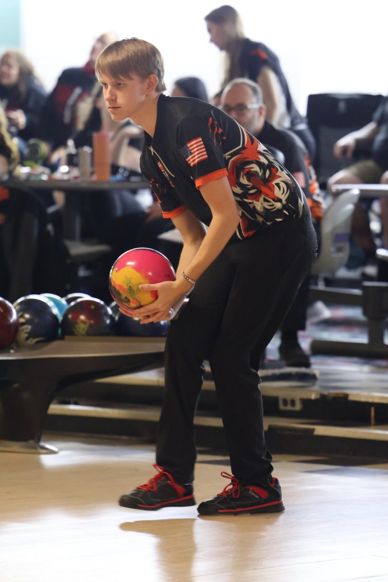 In stance, senior Brady Mitchell gets ready to swing the ball. On Feb. 5, the boys bowling team beat Linden 20-10.