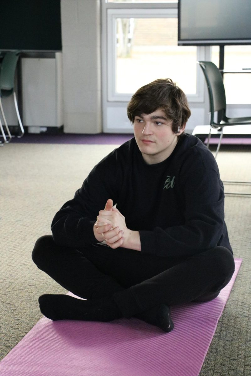 Meditating, senior Christopher Curtis participates in yoga. On Feb, 6. yoga was held in the project room by Mrs. Hasel.